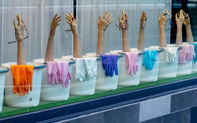 Bins, gloves and plastic arms decorate the window of a glasses shop in Frankfurt, Germany, Tuesday, June 11, 2019. (Photo by Michael Probst/AP Photo)