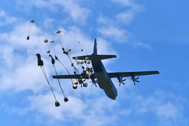 U.S. Army paratroopers assigned to the Brigade Support Battalion, 173rd Airborne Brigade, release heavy drop packages with a U.S. Air Force 86th Air Wing C-130 Hercules aircraft onto Frida Drop Zone at Pordenone, Italy on May 17, 2022. The 173rd Airborne Brigade is the U.S. Army's Contingency Response Force in Europe, providing rapidly deployable forces to the United States European, African, and Central Command areas of responsibility. Forward deployed across Italy and Germany, the brigade routinely trains alongside NATO allies and partners to build partnerships and strengthen the alliance. (Photo by Paolo Bovo/US Army/South West News Service)