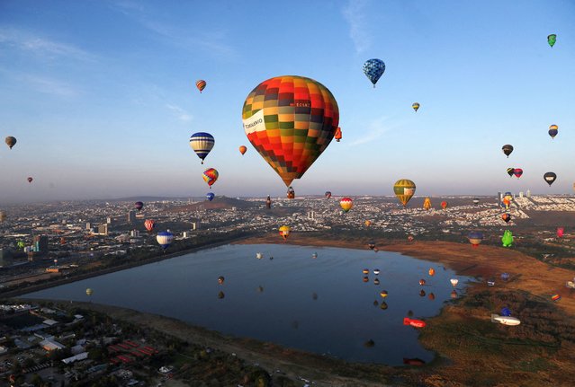 Hot-air balloons fly over Metropolitano park during the International Hot-Air Balloon Festival in Leon, in the state of Guanajuato, Mexico, on November 16, 2024. (Photo by Henry Romero/Reuters)