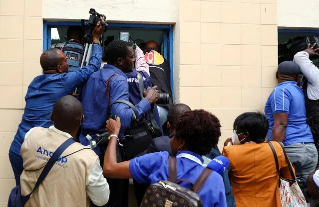 Members of the media jostle for space as Angola's President and leader of the People's Movement for the Liberation of Angola (MPLA) ruling party, Joao Lourenco, casts his vote in the general election in the capital Luanda, Angola on August 24, 2022. (Photo by Siphiwe Sibeko/Reuters)