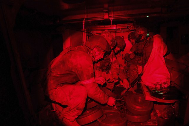 Ukrainian soldiers of Skala Battalion load anti-tank mines into an armored vehicle before departure to at the frontline positions towards Pokrovsk, Donetsk region, Ukraine, December 25, 2024. (Photo by Evgeniy Maloletka/AP Photo)