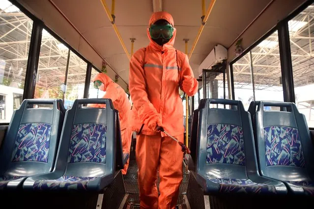 Health officiasl of the Ryonmot Trolley Bus Office disinfect a trolley bus, as part of preventative measures against the Covid-19 coronavirus in Pyongyang on June 9, 2022. (Photo by Kim Won Jin/AFP Photo)