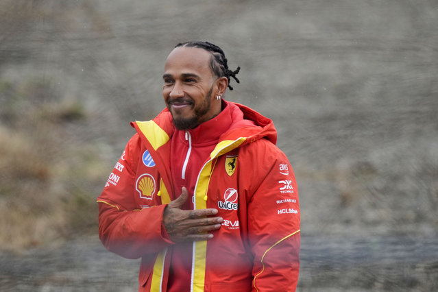 British driver Lewis Hamilton greets Ferrari fans gathered outside the track, after testing a Ferrari Formula One SF-23, in Fiorano Modenese, Italy, Wednesday, January 22, 2025. (Photo by Luca Bruno/AP Photo)