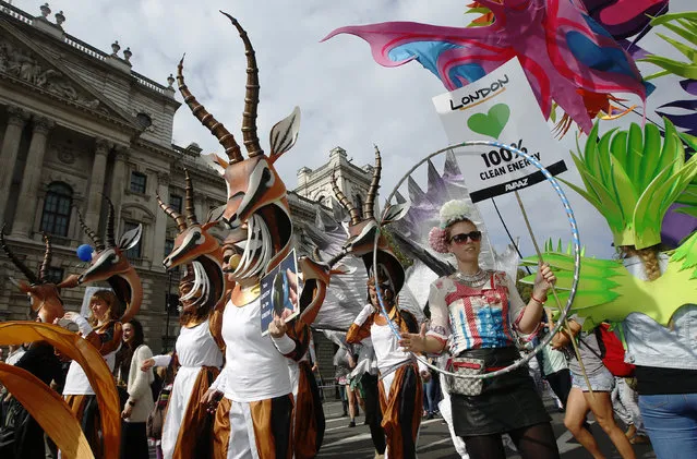 Demonstrators in animal costumes walk in the “People's Climate March” in central London September 21, 2014. (Photo by Luke MacGregor/Reuters)