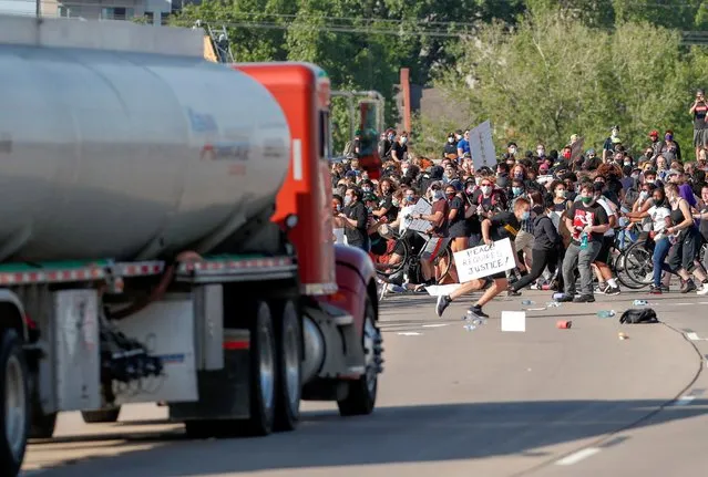 A tanker truck drives into thousands of protesters marching on 35W northbound highway during a protest against the death in Minneapolis police custody of George Floyd, in Minneapolis, Minnesota, May 31, 2020. A tanker truck drove into protesters on interstate highway 35 West in Minneapolis, but none of the marchers were injured, according to a Reuters witness. The driver then got out of the truck and was beaten by protesters, the Reuters witness said. (Photo by Eric Miller/Reuters)