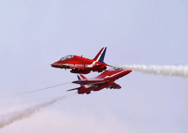 The Red Arrows, the British Royal Air Force Aerobatic Team, performs at the Malta International Airshow 2013 at Malta International Airport, outside Valletta, September 29, 2013. (Photo by Darrin Zammit Lupi/Reuters)