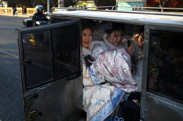 A group of women in Qing dynasty costumes takes an electric tricycle outside the Forbidden City in Beijing on February 19, 2025. (Photo by Wang Zhao/AFP Photo)