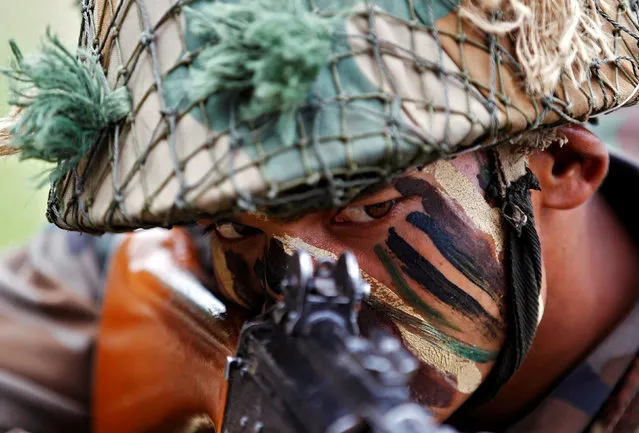An Indian Army soldier participates in a war exercise during a two-day “Know Your Army” exhibition in Ahmedabad, India, August 19, 2016. (Photo by Amit Dave/Reuters)