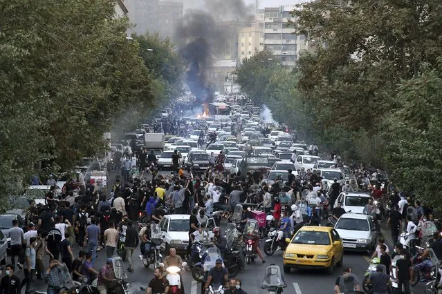 In this Wednesday, September 21, 2022, photo taken by an individual not employed by the Associated Press and obtained by the AP outside Iran, protesters chant slogans during a protest over the death of a woman who was detained by the morality police, in downtown Tehran, Iran. Iranians saw their access to Instagram, one of the few Western social media platforms still available in the country, disrupted on Wednesday following days of the mass protests. (Photo by AP Photo/Stringer)
