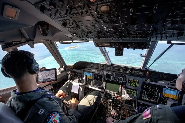 US Coast Guard pilot Ricardo Rodríguez (L) and co-pilot Hanna Boyce (R) check the ocean during their patrol and law Enforcement flight over the Florida Straits aboard of a HC-144 Medium Range Surveillance Aircraft, departed from the US Coast Guard Air Station Miami in Miami, Florida, USA, 24 October 2022. According to the US Government, the Homeland Security Task Force enhanced its operational posture and readiness to address a recent increase in irregular maritime migration originating from the Bahamas and Cuba through the Florida Straits, from Haiti through the Windward Pass, and from the Dominican Republic to Puerto Rico through the Mona Pass. (Photo by Cristobal Herrera-Ulashkevich/EPA/EFE)