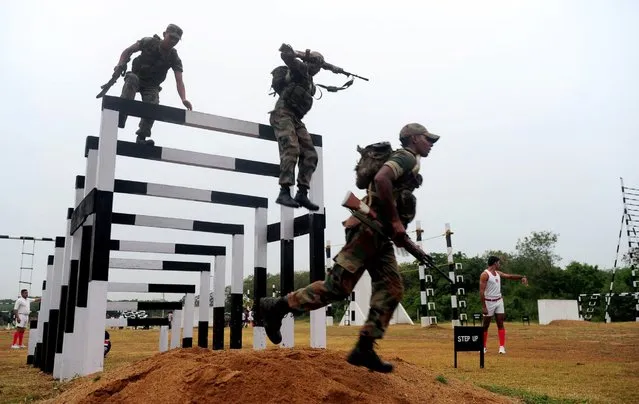 Indian cadets jump during an obstacle course at an Officers Training Academy in Chennai, August 26, 2016, where India's President Pranab Mukherjee is scheduled to review a passing out parade of cadets in September. (Photo by Arun Sankar/AFP Photo)