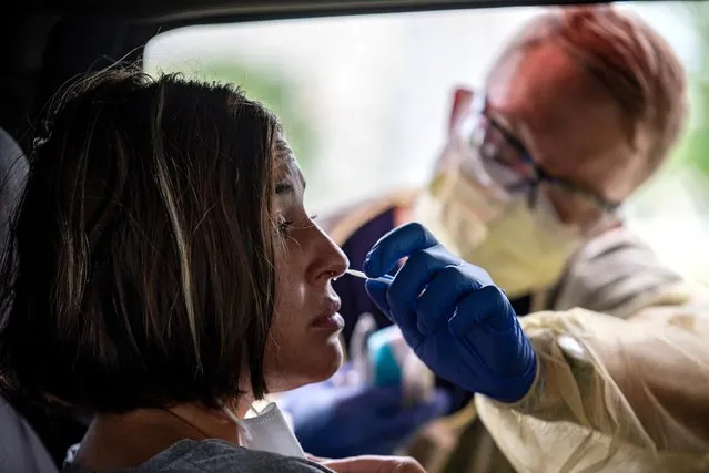 Atealla Betancourt is tested in a car for coronavirus disease (COVID-19) during an outbreak, in Austin, Texas, U.S., June 28, 2020. (Photo by Sergio Flores/Reuters)