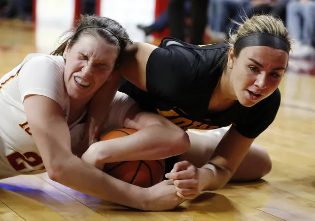 Iowa State guard Bridget Carleton, left, scrambles for a loose ball with Iowa forward Hannah Stewart during the second half of an NCAA college basketball game, Wednesday, December 6, 2017, in Ames, Iowa. Iowa won 61-55. (Photo by Charlie Neibergall/AP Photo)