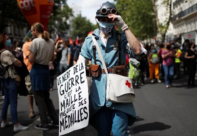 French health workers attend a demonstration on the Bastille Day in Paris, as part of a nationwide day of actions to urge the French government to improve wages and invest in public hospitals, in France, July 14, 2020. (Photo by Gonzalo Fuentes/Reuters)