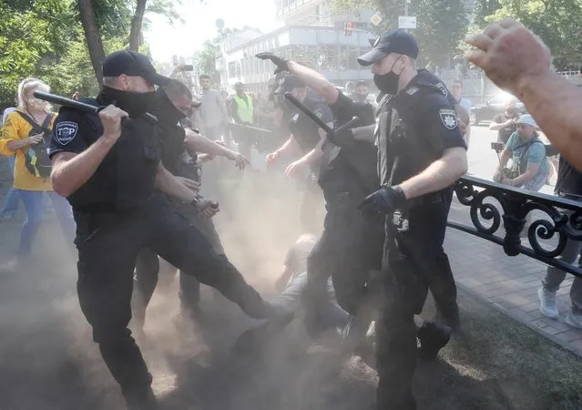 Protesters clash with police officers during a rally against a bill, which offers to extend the use of the Russian language in the educational system of Ukraine, near the parliament building in Kyiv, Ukraine on July 17, 2020. (Photo by Gleb Garanich/Reuters)
