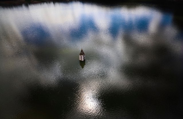 The belfry an 11th century Romanesque church emerges from the Sau reservoir, about 100 km (62 miles) north of Barcelona, in Vilanova de Sau, Spain, on Monday, March 24, 2025. (Photo by Emilio Morenatti/AP Photo)