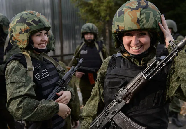 Members of a rapid action team laugh during training in Nizhny Tagil, Russia on October 1, 2015. The unit consists of 17 female employees of the 6th Nizhny Tagil women’s prison colony, established to prevent crimes in the colony. (Photo by Tass/Barcroft Media)