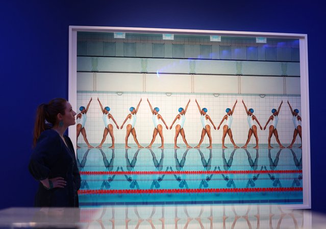 A staff member looks at “Movement” (2020) a photograph by Maria Svarbova on display at the Splash! A Century of Swimming and Style exhibition which will begin at the Design Museum in London, Britain, on March 24, 2025. (Photo by Isabel Infantes/Reuters)