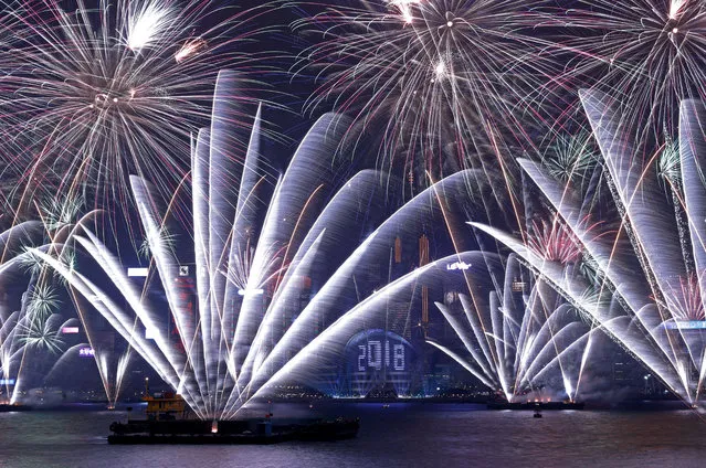 Fireworks explode over Victoria Harbour and Hong Kong Convention and Exhibition Centre during a pyrotechnic show in Hong Kong, China on December 31, 2017. (Photo by Tyrone Siu/Reuters)