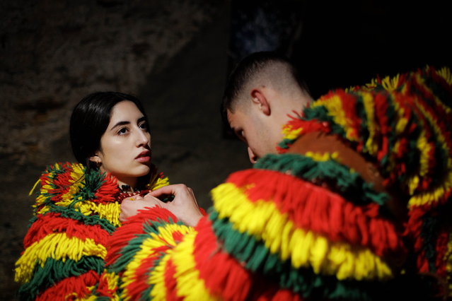Participants dressed as “Caretos'” during the carnival festivities of Podence, municipality of Macedo de Cavaleiros, Portugal, 11 February 2024. Every year, during carnival, the Caretos de Podence – masked boys in costumes with colourful fringes, pointed-nosed faces made of tin or leather and rattles around their waists – roam the streets of the town making noise and picking on people passing by, especially girls. (Photo by Pedro Sarmento Costa/EPA)