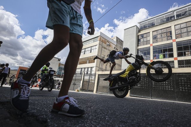 Motorcyclists perform acrobatics on their motorcycles, during the 1st Great Meeting of MotoPiruetas 2025, in the neighborhood of Petare, in Caracas, Venezuela on February 09, 2025. This questioned practice was declared as a new "National Sport" by President Nicolas Maduro, despite strong criticism from Venezuelans for this type of motorcycle stunts. (Photo by Pedro Rances Mattey/Anadolu via Getty Images)