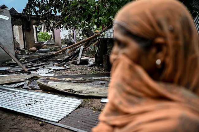 A woman stands outside a house destroyed by Pakistani artillery shelling at the Salamabad village in Uri, about 110kms from Srinagar, on May 8, 2025. India's government said on May 8 that Pakistan launched an overnight air attack using “drones and missiles”, before New Delhi retaliated to destroy an air defence system in Lahore. “Pakistan attempted to engage a number of military targets ... using drones and missiles”, India's defence ministry said in a statement, adding that "these were neutralised" by air defence systems. (Photo by Sajjad Hussain/AFP Photo)