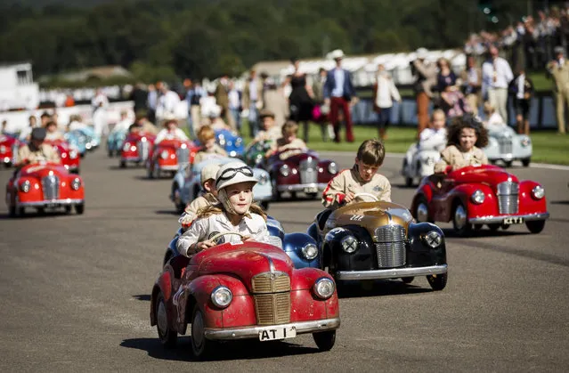 Children take part in a vintage pedal car race during the Goodwood Revival at Goodwood on September 11, 2016 in Chichester, England. (Photo by Tristan Fewings/Getty Images)
