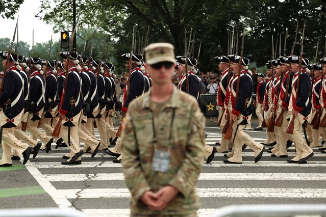 Participants in vintage uniforms take part in the parade in Washington on June 14, 2025. (Photo by Kevin Mohatt/Reuters)