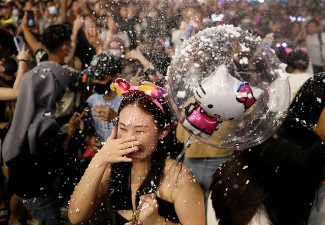 A reveler celebrates New Year's Eve in Kuala Lumpur, Malaysia on December 31, 2022. (Photo by Hasnoor Hussain/Reuters)