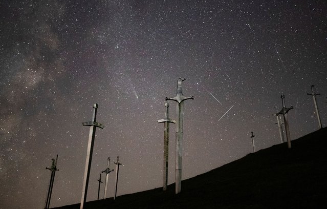 A view shows comet C/2023 A3 - Tsuchinshan-ATLAS, meteors and satellite trails in the night sky above the Battle of Didgori memorial complex in Didgori, Georgia on October 30, 2024. (Photo by Irakli Gedenidze/Reuters)