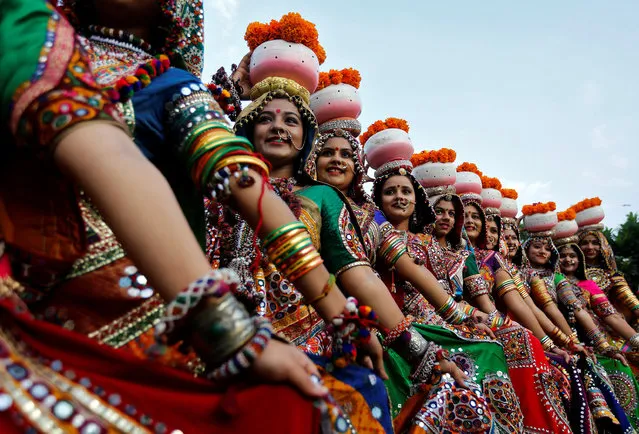 Women dressed in traditional attire pose after taking part in rehearsals for Garba, a folk dance, ahead of Navratri, a festival when devotees worship the Hindu goddess Durga, in Ahmedabad, India, September 25, 2016. (Photo by Amit Dave/Reuters)