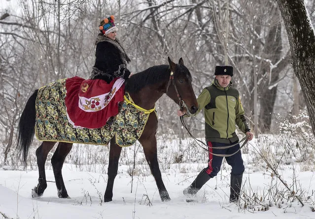 A woman in festive costume rides a horse during the festivities of Shrovetide or Maslenitsa in the village of Leninskoe, some 20 km from Bishkek, on February 18, 2018. Shrovetide or Maslenitsa is an Eastern Slavic religious and folk holiday. (Photo by Vyacheslav Oseledko/AFP Photo)