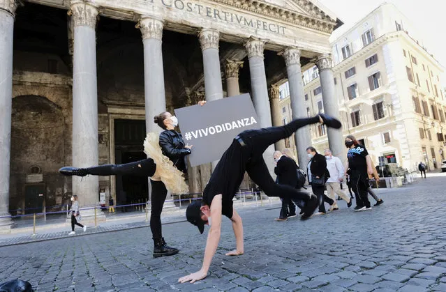 Dancing schools operators perform in front of the Pantheon as they stage a protest against the government restriction measures to curb the spread of COVID-19, in Rome, Thursday, October 22, 2020. Authorities in regions including Italy's three largest cities have imposed curfews in a bid to slow the spread of COVID-19 where it first struck hard in Europe, most of whose countries are now imposing, or mulling, new restrictions to cope with rapidly rising caseloads. (Photo by Mauro Scrobogna/LaPresse via AP Photo)