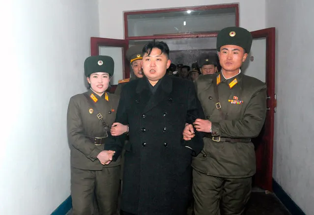 Closely escorted, North Korean leader Kim Jong Un visits the Command of Large Combined Unit 671 of the Korean People's Army in this undated picture released by the North's KCNA in Pyongyang, on January 22, 2012. (Photo by Reuters/KCNA)