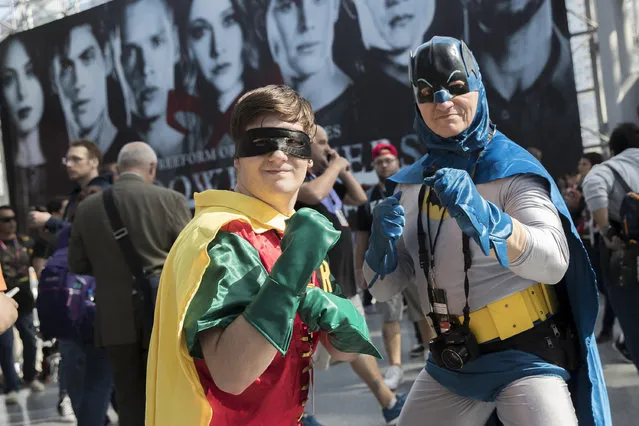 Father and son team Jason Paige, right, and Matt Paige, of Queens, attend Comic Con as Batman and Robin, Thursday, October 6, 2016, in New York. The event runs through Oct. 9th at the Javitz Center and the Hammerstein Ballroom. (Photo by Mary Altaffer/AP Photo)