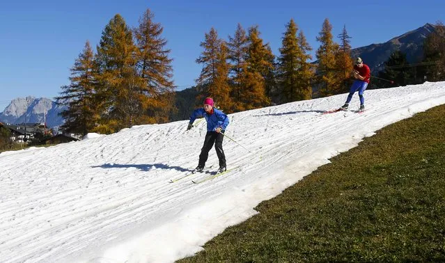 Cross country skiers ski on an artificial slope during a sunny autumn day in the Western Austrian village of Seefeld, Austria November 5, 2015. (Photo by Dominic Ebenbichler/Reuters)