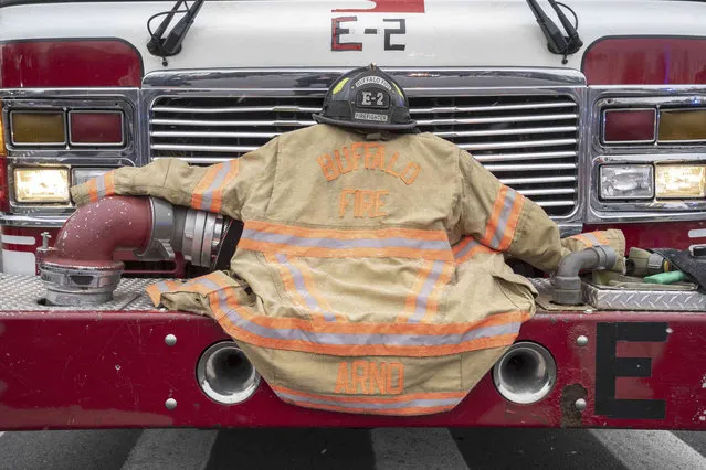 The bunker gear for Buffalo Firefighter Jason Arno is carried on the front of Engine 2 in Buffalo, N.Y., on Friday, March 10, 2023. The 37-year-old father who had been with the department for three years was killed in an explosive blaze. (Photo by Harry Scull Jr./The Buffalo News via AP Photo)