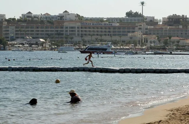 Tourists swim in the sea in the Red Sea resort of Sharm el-Sheikh, November 7, 2015. (Photo by Asmaa Waguih/Reuters)