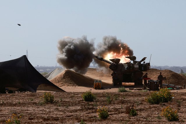An Israeli military vehicle fires near the Israel-Gaza border, amid the ongoing conflict between Israel and the Palestinian Islamist group Hamas, in southern Israel, on May 8, 2024. (Photo by Ammar Awad/Reuters)