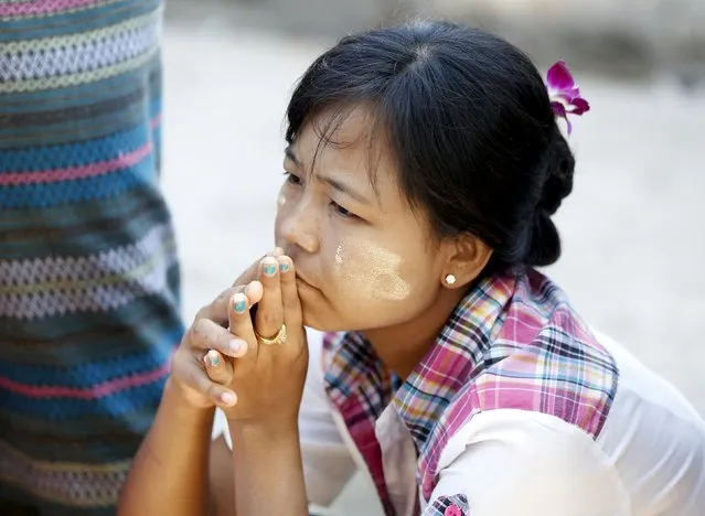 A woman waits to cast her ballot during the general election in Mandalay, Myanmar, November 8, 2015. (Photo by Olivia Harris/Reuters)