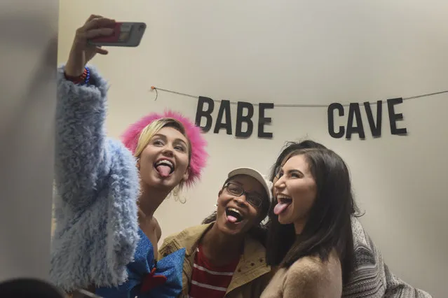 Singer, songwriter, actress and philanthropist Miley Cyrus, L, takes a selfie while doing her signature tongue-out pose with GMU students Samaria Moss, 18, C, of Spottsylvania, VA, Jaide Tarwid, 18, from Wisconsin, and Zimuzo Okala, 19, of Chesapeake, VA, (blocked) as Cyrus makes a campaign visit for Hillary Clinton and Tim Kaine in Northern Virginia at George Mason University on Saturday, October 22, 2016 in Fairfax, VA. (Photo by Jahi Chikwendiu/The Washington Post)