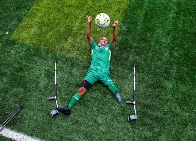 Warna Di, a 32-year-old a player from Garuda Indonesia Amputee Football (Garuda INAF), lies on the turf during the International Day of Persons with Disabilities in Jakarta, Indonesia, December 3, 2020. (Photo by Ajeng Dinar Ulfiana/Reuters)