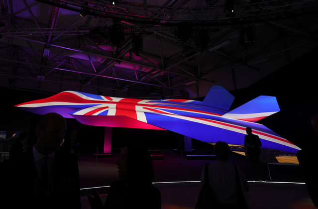 Attendees view the GCAP (Global Combat Air Programme) concept model fighter plane at the BAE Systems pavilion at the Farnborough International Airshow, in Farnborough, Britain, on July 22, 2024. (Photo by Toby Melville/Reuters)