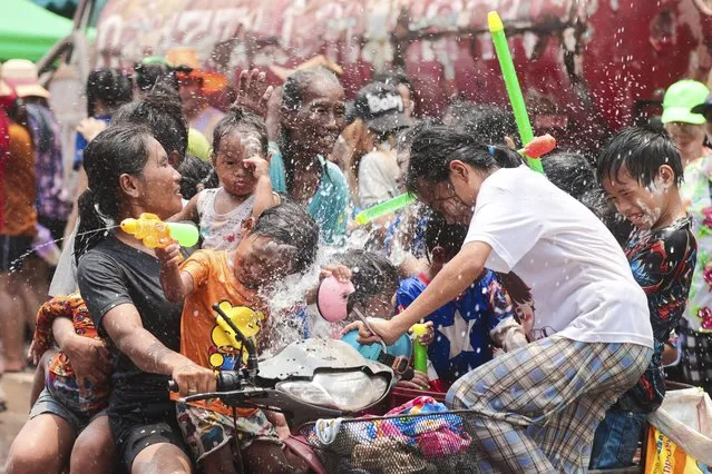 A family celebrate Songkran festival in Prachinburi Province, east of Bangkok. Thursday, April 13, 2023. (Photo by Wason Wanichakorn/AP Photo)