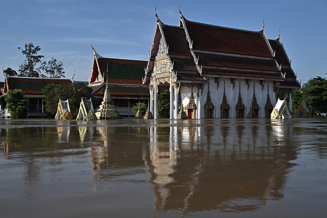 Flood waters are seen at Wat Taku Buddhist temple in Bang Ban district in the central Thai province of Ayutthaya on November 14, 2025. (Photo by Lillian Suwanrumpha/AFP Photo)
