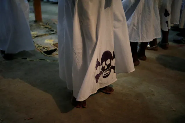 A voodoo believer dances in a dress decorated with a skull and crossbones during a celebration of Fet Gede in a Peristil, a voodoo temple, in Port-au-Prince, Haiti, November 1, 2016. (Photo by Andres Martinez Casares/Reuters)