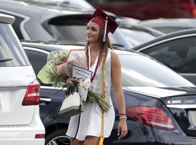 Graduate Shannon Recor leaves a graduation ceremony for Marjory Stoneman Douglas seniors, Sunday, June 3, 2018, in Sunrise, Fla. The senior class from Florida's Parkland high school where a gunman killed 17 people in February received diplomas Sunday and heard from surprise commencement speaker Jimmy Fallon, who urged graduates to move forward and “don't let anything stop you”. (Photo by Lynne Sladky/AP Photo)
