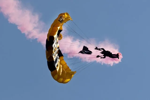 US Army Parachute Team Golden Knights perform a precision drop to commemorate the 50th anniversary of the end of the Vietnam War, above West Potomac Park in Washington, DC, USA, 11 May 2023. The performance is one of many activites being held on the National Mall over three days to honor Vietnam War veterans and their families and to commemorate the 50th anniversary of when the last US combat troops left South Vietnam in 1973. (Photo by Michael Reynolds/EPA/EFE)