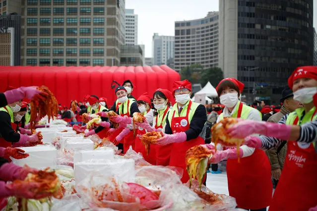 People make traditional side dish Kimchi during the Seoul Kimchi Festival in central Seoul, South Korea, November 4, 2016. (Photo by Kim Hong-Ji/Reuters)