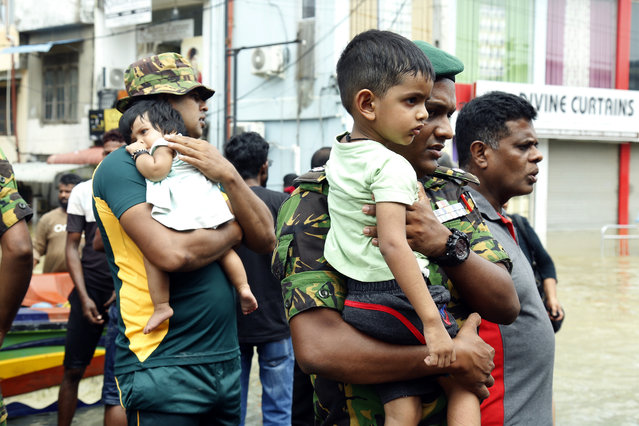 Security forces personnel and volunteers rescue flood victims in Wellampitiya, a suburb of Colombo, Sri Lanka on December 01, 2025. A total of 998.918 people across all 25 districts in the island nation have now been affected, with 212 deaths reported and 218 people missing. More than 180.000 people from over 51.000 families are sheltering in 1.094 government-run safety centers as search and rescue efforts continue following Cyclone Ditwah which hit Sri Lanka since Nov. 28, according to the UN relief coordination office OCHA. (Photo by Pushpa Kumara/Anadolu via Getty Images)